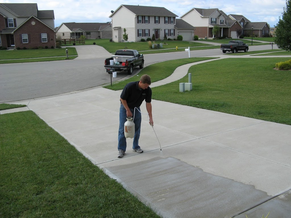 Man sealing concrete